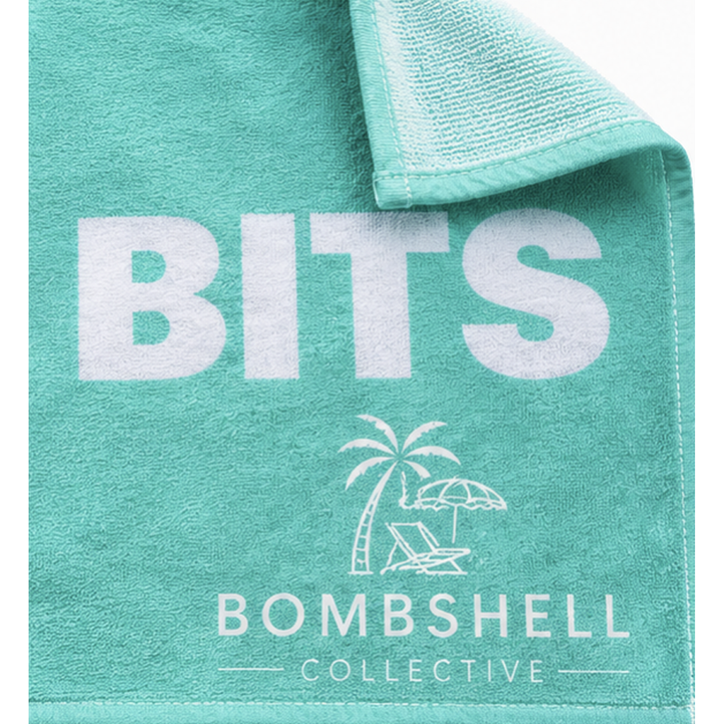 Close-up of Aqua Face Bum Bits bath towel showing textured fabric, white lettering and Bombshell Collective palm tree logo.