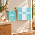 Bombshell Collective Bathroom Duo in Aqua featuring the Face Bum Bits bath towel and matching Hot Stuff hand towel.