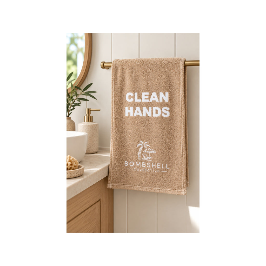 Neutral sand bathroom hand towel featuring the playful Clean Hands slogan
