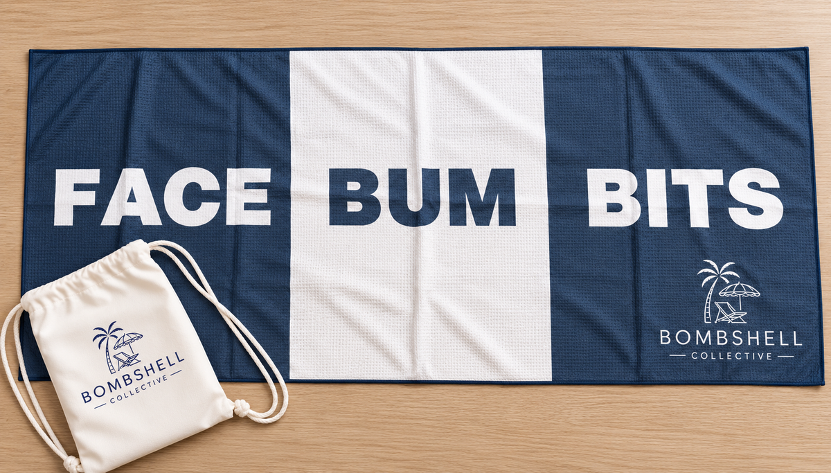 Bombshell Collective large Face Bum Bits beach towel in deep sea blue, featuring sand-free waffle microfibre fabric, bold lettering and a matching waterproof carry bag.