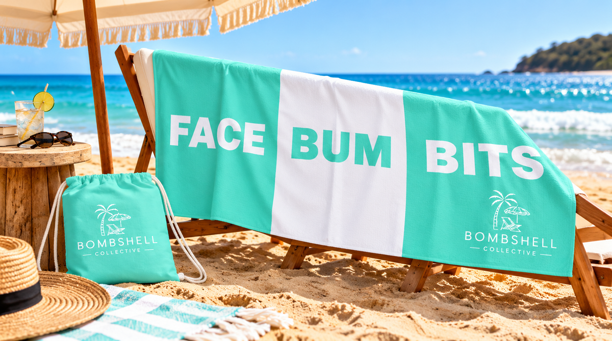 Flatlay of the large Bombshell Collective Face Bum Bits beach towel in aqua with matching waterproof carry bag, perfect for holding personal beach essentials.